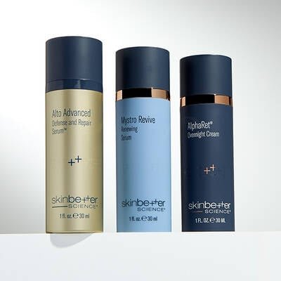 Three skinbetter science products lined up horizontally on a pale grey surface